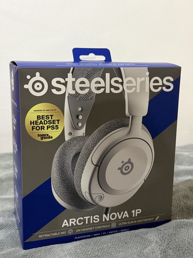 SteelSeries Arctis Nova 1P Gaming Headset for PS5, PC, Switch (Category: Headphones & Headsets) located in Quezon City. Submitted by ma.gabriellahernandez (Listing ID 1446816978, Image 1). Description: - SteelSeries Arctis Nova 1P Headset - Color: White and Grey - Ultra slim and lightweight design - Retractable noise-canceling microphone - Convenient on-headset controls - Wide compatibility: PlayStation, Xbox, PC, Nintendo Switch, and Mobile devi