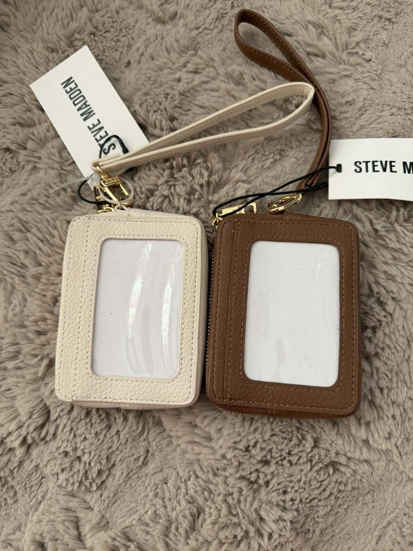 Steve Madden Cardholder Set with Lanyard (Category: Wallets & Card holders) located in San Leonardo. Submitted by arni0179 (Listing ID 1446850724, Image 3). Description: - Two Steve Madden cardholders: one cream, one brown. - Features a clear ID window on one side. - Multiple card slots on the other side. - Includes a detachable lanyard strap for convenience. - Elegant gold hardware details. - Ideal for organizing and easily accessing your essent
