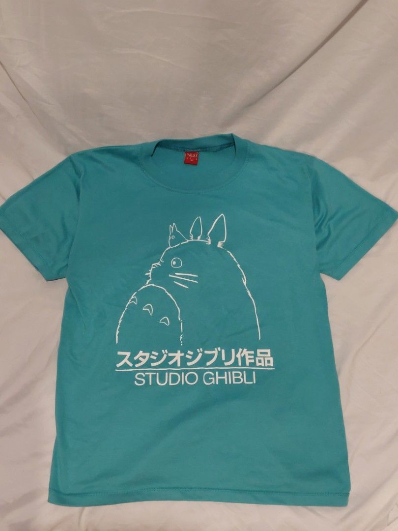 Studio Ghibli Totoro Teal T-Shirt Size M (Category: Shirts) located in Rizal. Submitted by mariririe (Listing ID 1446834921, Image 1). Description: helping my sister! LP: 100 - Teal t-shirt featuring a Studio Ghibli Totoro graphic. - Includes Japanese text and 'STUDIO GHIBLI' print on the side. - Tag reads 'YALEX GOLD M' (fits like a Medium). - Ideal gift for any Studio Ghibli enthusiast..