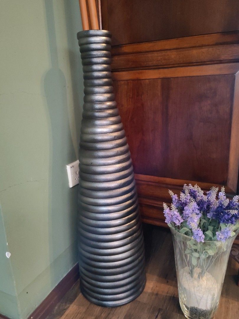 Tall decorative floor vase, ribbed design, silver finish (Category: Vases & Decorative Bowls) located in Kuala Lumpur. Submitted by gentlepenguin.6b8aad (Listing ID 1446764986, Image 1). Description: - Large floor vase - Unique ribbed texture - Metallic silver color - Tall statement piece (approx. 36 inches height) - Perfect for dried flowers or branches.