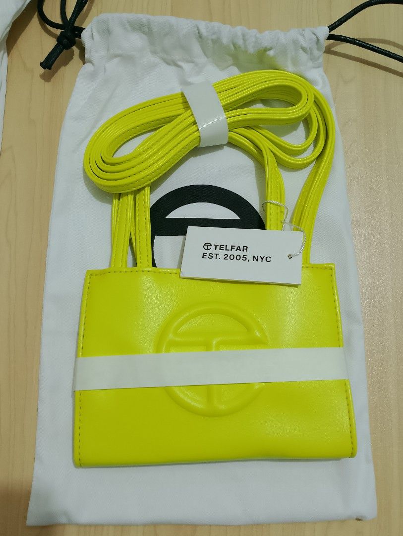 Telfar Small Shopping Bag (Category: Luxury Bags & Wallets) located in Quezon City. Submitted by marikamnl.crystal (Listing ID 1446750595, Image 3). Description: Authentic Telfar Bag Colors: Butter Yellow Highlighter Yellow Highlighter Green Pool Blue Featuring a double strap (handles and cross-body straps), embossed logo, and magnetic snap closure. Made from faux leather and twill lining. Bag is packaged in a drawstring bag with screen-printed l