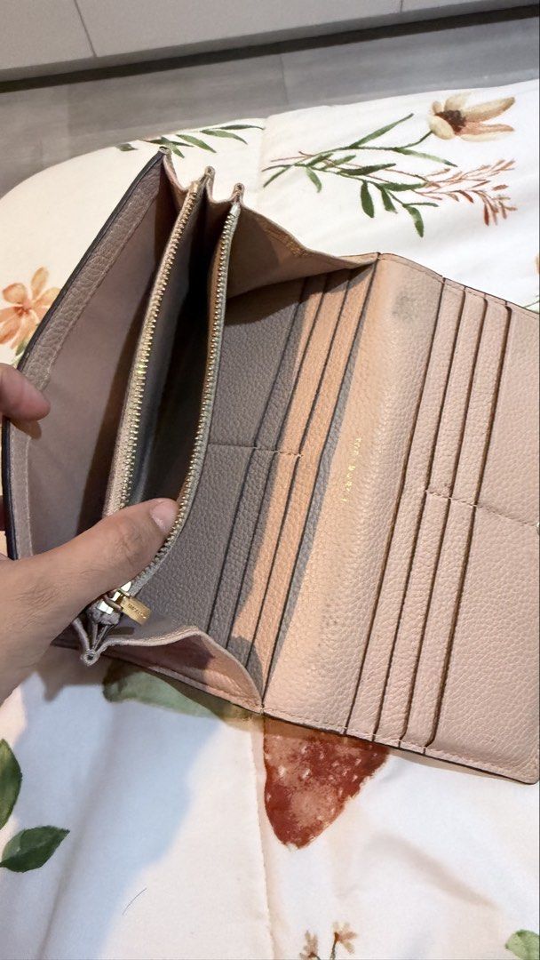 Tory Burch Pink Leather Trifold Wallet (Category: Wallets & Card holders) located in Mandaluyong City. Submitted by stuffnmore (Listing ID 1446850278, Image 3). Description: - Authentic Tory Burch pink leather trifold wallet - Multiple card slots for organization - Secure zippered compartment for coins or essentials - Minor marks inside, as pictured - needs cleaning.
