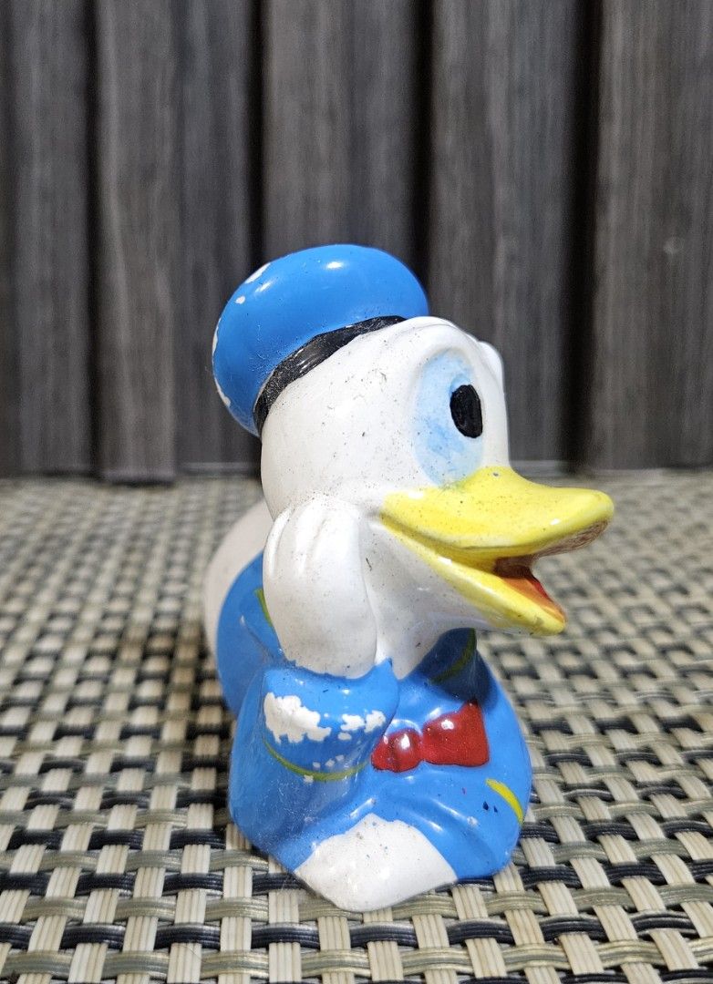 Vintage Ceramic Donald Duck Figurine (Category: Other Home Decor) located in Rizal. Submitted by cherry_garcia (Listing ID 1446786679, Image 3). Description: - Adorable ceramic Donald Duck figurine - Classic lying down pose with sailor outfit - Approximately 4 inches in length - Minor paint wear, adding to its vintage charm - Ideal for Disney collectors and desk decoration.
