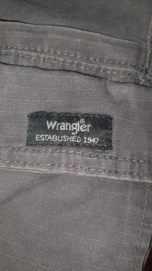Wrangler Relaxed Fit Cargo Shorts (Category: Shorts) located in Manila. Submitted by deblong_ (Listing ID 1446893565, Image 3). Description: - Brand: Wrangler - Fit: Relaxed - Color: Dark Blue/Grey - Style: Cargo Shorts - Features: Multiple pockets for ample storage - Material: Durable fabric - Ideal for: Casual wear, outdoor activities - Benefits: Comfortable and practical.
