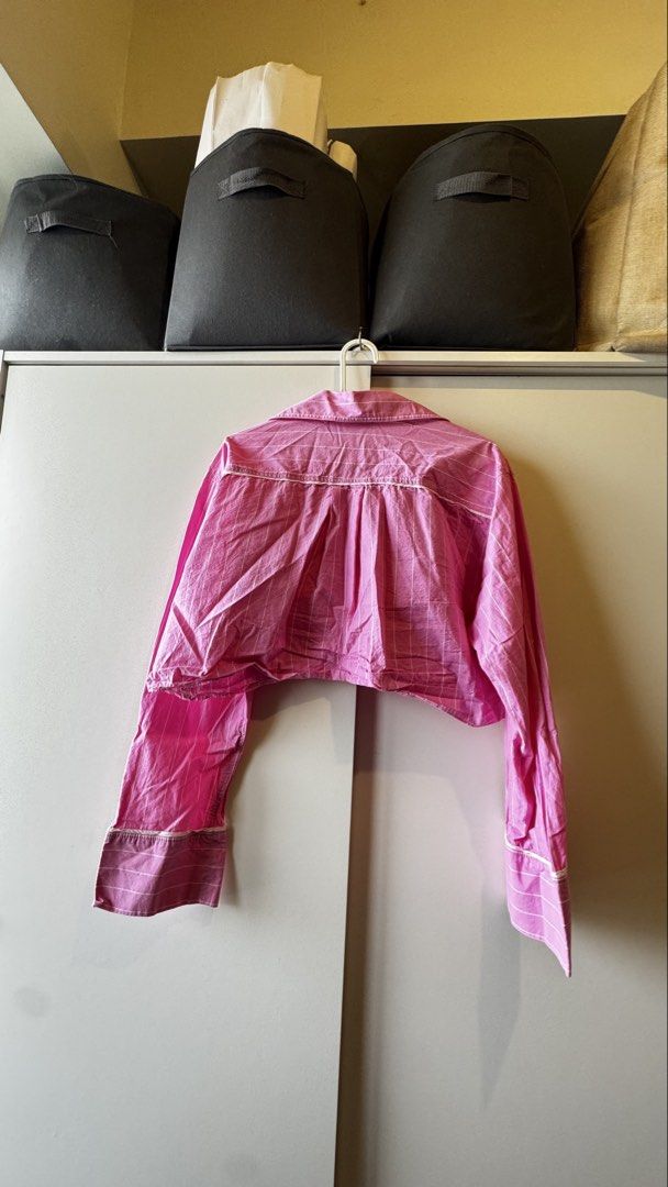 ZARA Pink Striped Cropped Shirt (Category: Shirts) located in Pasig City. Submitted by pat.closetcleanup (Listing ID 1446869645, Image 2). Description: - Pink cropped shirt from ZARA - White pinstripe pattern - Collared neckline - Long sleeves with buttoned cuffs - Pajama shirt style - Size: Medium (M) - Ideal for a casual outfit.