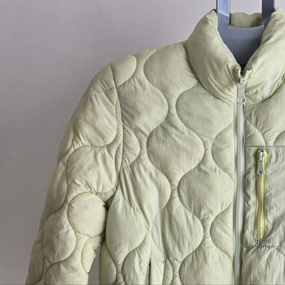 Zara Quilted Puffer Jacket Light Yellow Size 11-12 (Category: Coats, Jackets and Outerwear) located in Muntinlupa City. Submitted by prelovedby.maria (Listing ID 1446799284, Image 3). Description: - Zara light yellow quilted puffer jacket - Size: 11-12 years (CM 152) - Made in Vietnam - Features zip-up front - Includes a chest pocket with zip - Ideal for cooler weather - Easy to wear and style.