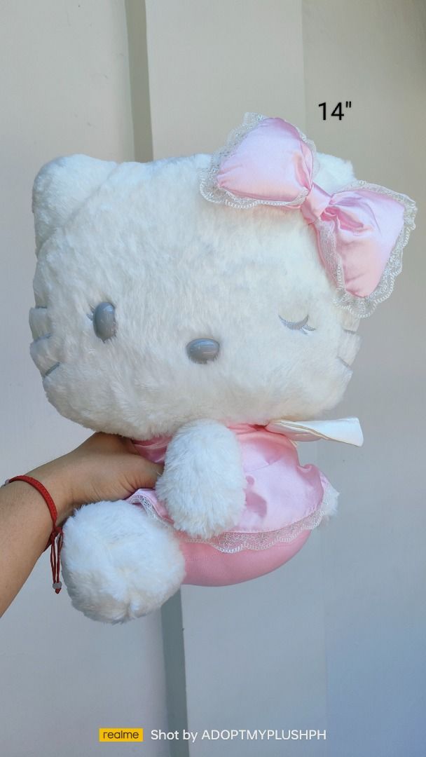 14" Sanrio Smiles Hello Kitty Angel plush (Category: Plushies & Soft Toys) located in Taguig. Submitted by adopt.my.plush.ph (Listing ID 1439684467, Image 1). Description: Sanrio Smiles Hello Kitty Angel plush. It features Hello Kitty styled as an angel with a winking expression, silver/grey eyelashes, a pink satin dress with white lace trim, a matching head bow, and a pair of small plush wings on her back. ‼️Last Price (LP) Posted *as is, WYSIWY
