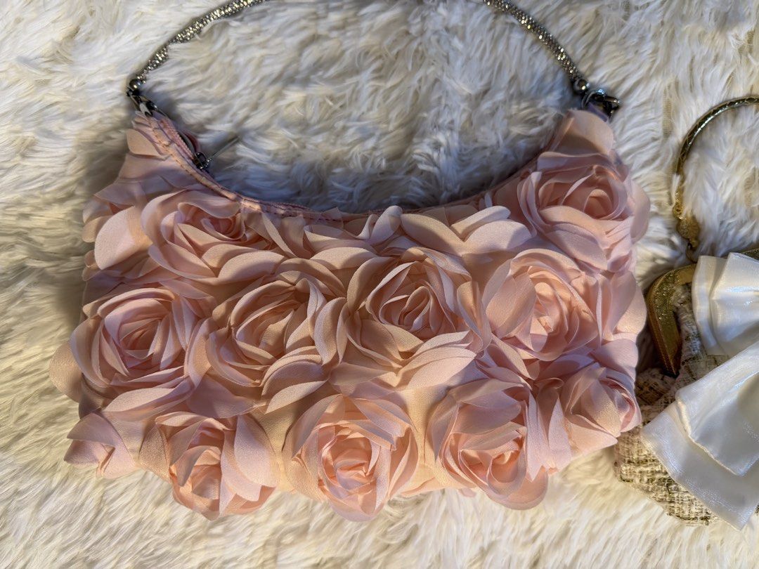 2x Evening Clutches - Rose & Bow Detail (Category: Clutches) located in Valenzuela. Submitted by cloudstarrr (Listing ID 1441840318, Image 2). Description: - Two adorable evening clutches perfect for parties and special occasions. - Clutch 1: Soft pink with charming 3D rose embellishments and a sparkly chain strap. - Clutch 2: Textured tweed with a statement large satin bow and elegant gold frame. - Both clutches are small and designed for easy c