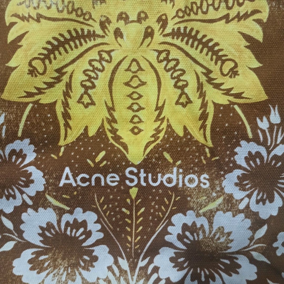 Acne Studios Brown Yellow Floral Print Tote Bag (Category: Tote Bags) located in Manila. Submitted by susanthrifts (Listing ID 1441945788, Image 2). Description: - Acne Studios tote bag - Features a brown and yellow floral print - Made from 100% cotton - Hand wash only - Ideal for everyday use - Please check photos for detailed condition.