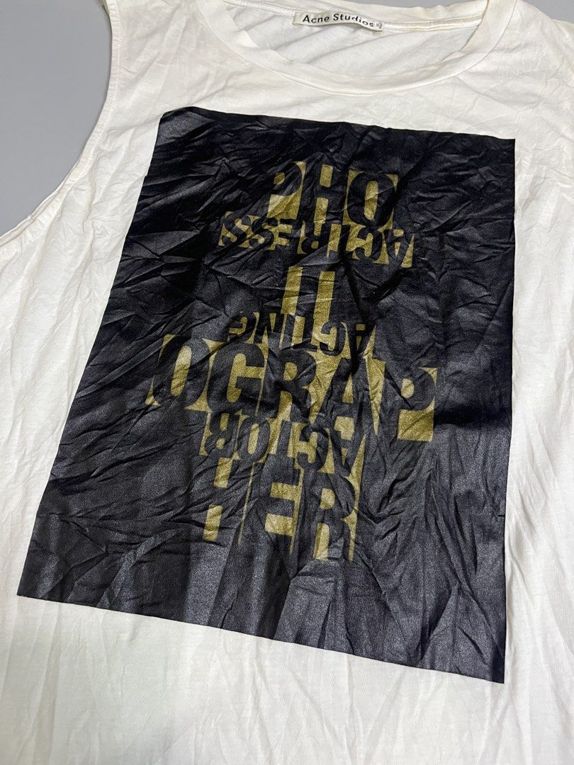 Acne Studios White Graphic Print Tank Top (Category: Sleeveless) located in Mabalacat. Submitted by aas_thriftfings (Listing ID 1441807653, Image 2). Description: - Acne Studios tank top - Black graphic print with gold text - Sleeveless design - Made in Portugal - Ideal for casual wear.