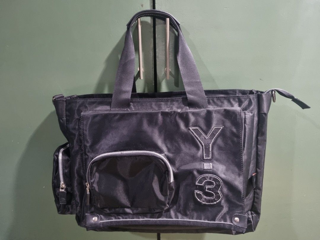 Adidas Y-3 Yohji Yamamoto Utility Travel Bag (Category: Tote Bags) located in Manila. Submitted by thrift.mercato (Listing ID 1441879414, Image 1). Description: Adidas Y-3 Yohji Yamamoto Utility Travel Bag. Late 2000s release. Good condition, all fine stitchings, w/ minimal scratches and signs of minimal usage. One big pocket in front, one small pocket in front and side. Two pockets inside the bag. Polyamide Nylon Material. Issues: Minimal scratc