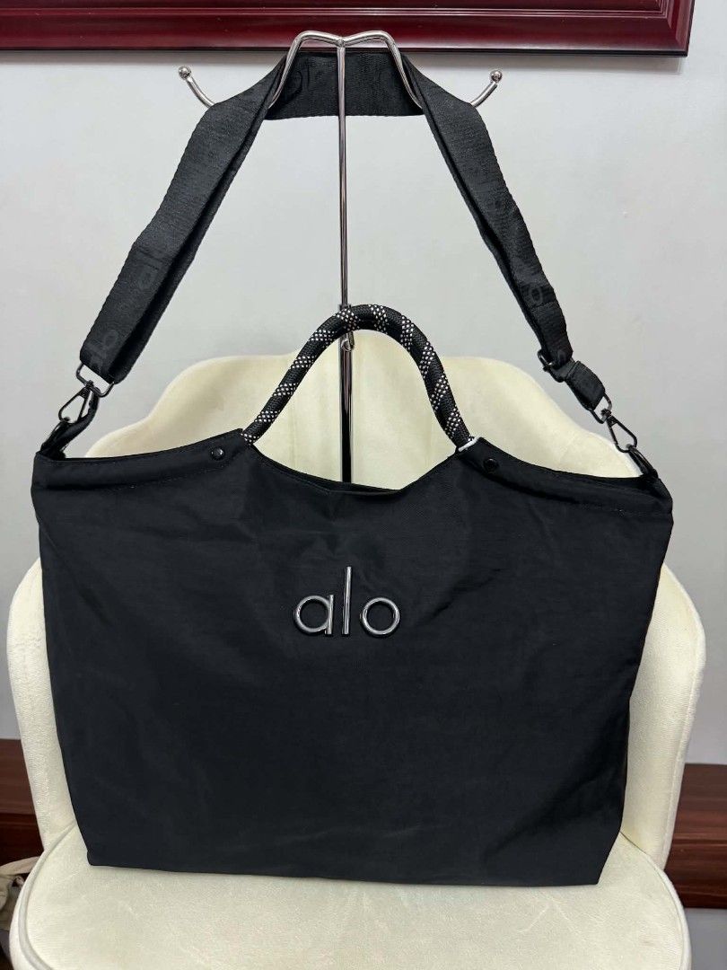 Alo tote bags 2way (Category: Tote Bags) located in Manila. Submitted by rcwessential (Listing ID 1441061083, Image 3). Description: This black Alo Yoga tote bag features distinctive braided rope handles and a subtle embroidered logo. [1, 2].
