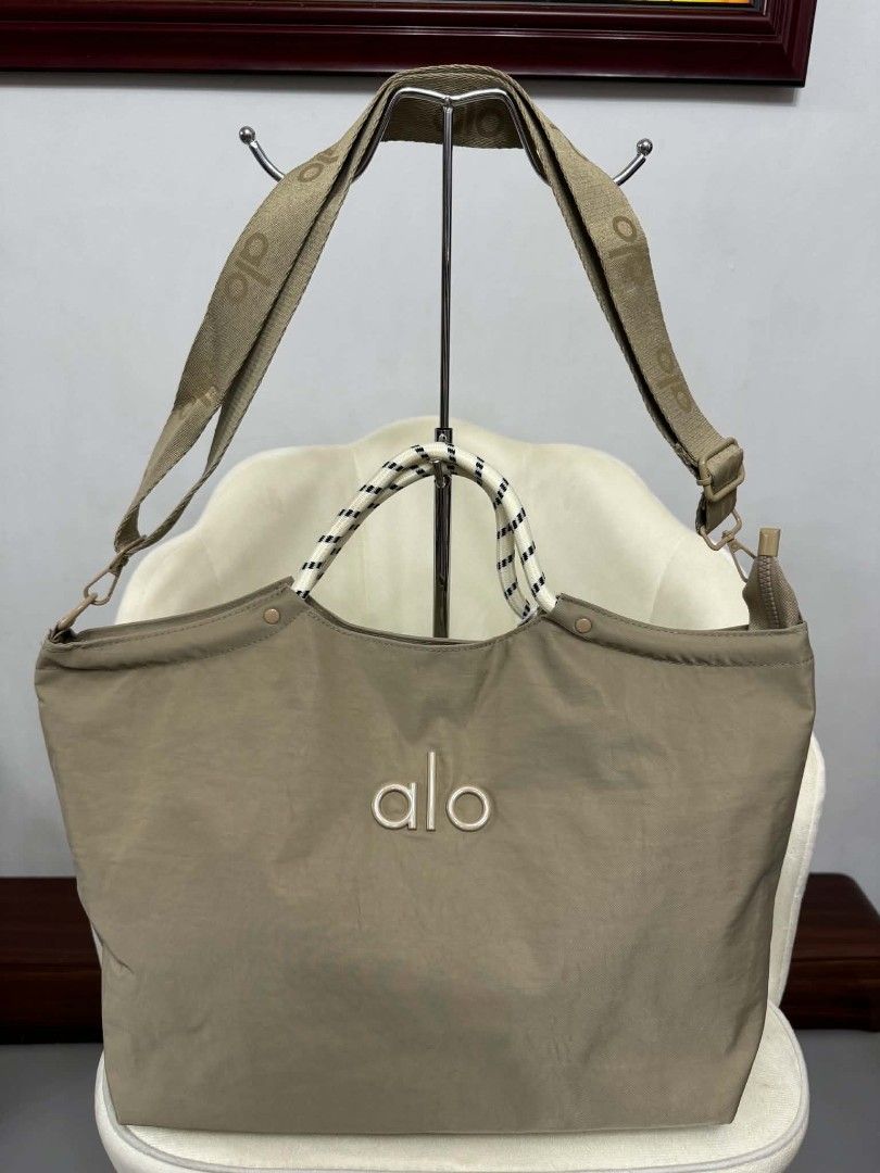 Alo tote bags 2way (Category: Tote Bags) located in Manila. Submitted by rcwessential (Listing ID 1441061083, Image 2). Description: This black Alo Yoga tote bag features distinctive braided rope handles and a subtle embroidered logo. [1, 2].