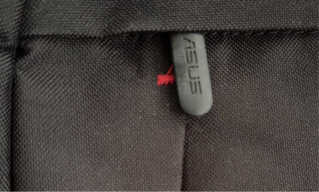 ASUS Black Backpack (Category: Backpacks) located in Antipolo. Submitted by lottientottie (Listing ID 1441850871, Image 3). Description: - Black ASUS backpack - Front zip pocket with red accent - Padded shoulder straps for comfort - Spacious interior - Ideal for everyday use or travel - Zippers in good working condition.