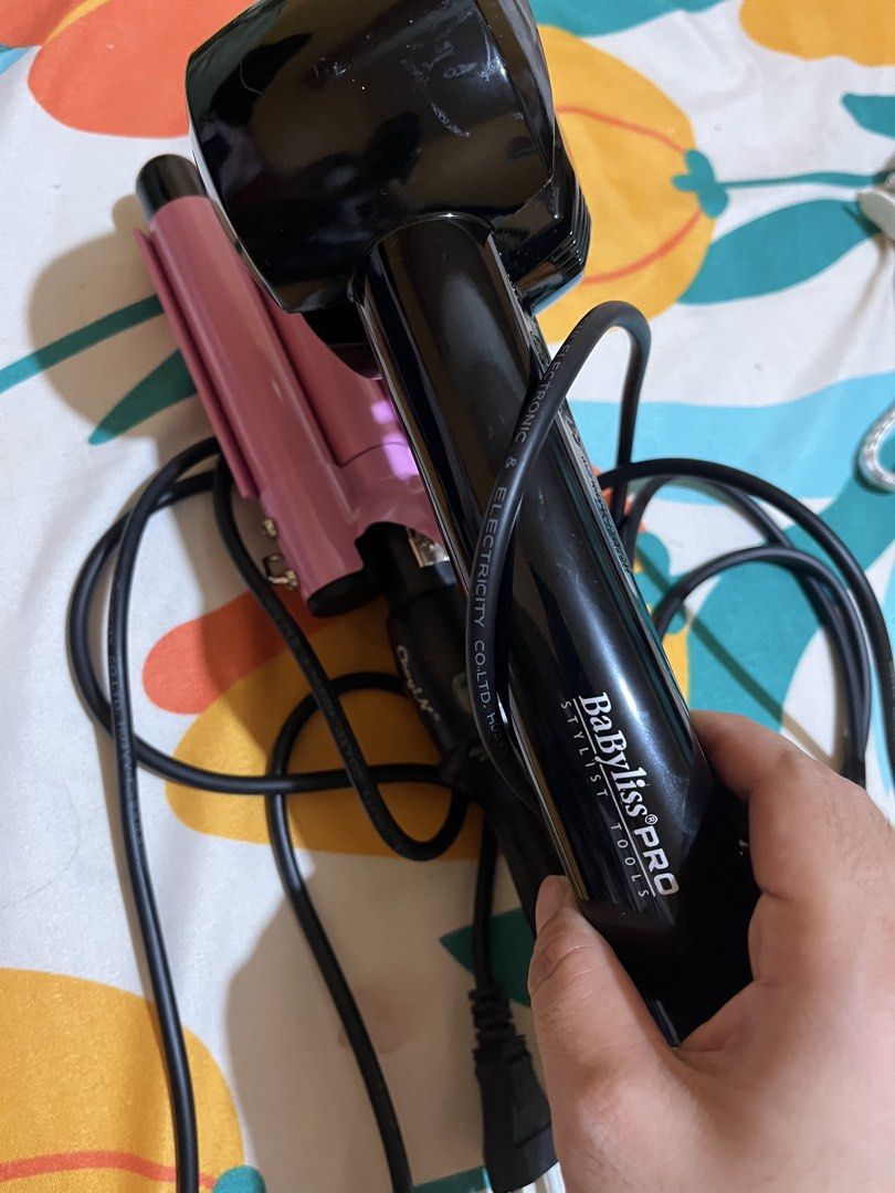 BaBylissPRO Stylist Tools Curling Iron (Category: Hair) located in Manila. Submitted by kenjordan541489 (Listing ID 1441830935, Image 2). Description: - BaBylissPRO Curling Iron for professional styling. - Features vibrant pink barrels for creating beautiful waves. - Equipped with a comfortable black handle and a durable cord. - Versatile for achieving a wide range of hairstyles and looks. - Achieve salon-quality curls and waves right at home..