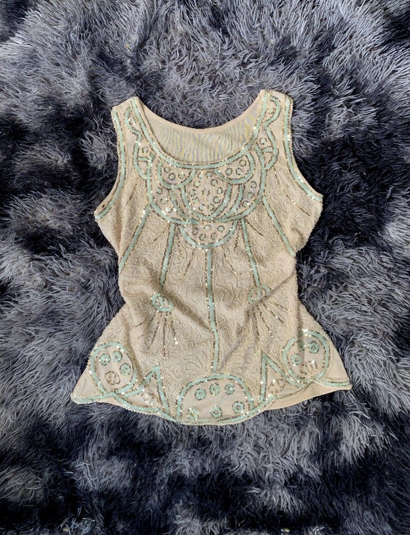 Beaded Sequin Flapper Top - Gatsby Style (Category: Sleeveless) located in Bislig. Submitted by styleeee (Listing ID 1441865524, Image 1). Description: - medium-large - Cream sleeveless top - Intricate beadwork and sequin embellishments - 1920s flapper-inspired style .
