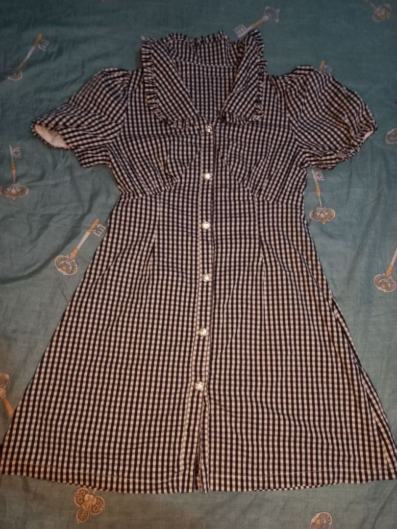 Black and White Gingham Button-Up Dress with Ruffle Collar (Category: Dresses) located in Marikina City. Submitted by gelandmeridor_015 (Listing ID 1441788463, Image 1). Description: - Can fit small to large - Adorable black and white gingham pattern - Short puff sleeves with ruffle details - Button-up front with eye-catching sparkly buttons - Chic ruffle collar - Flattering fit for any body type - Versatile for casual outings or dressing up.