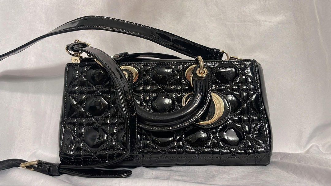 Black Patent Dior Lady Dior Bag (Category: Luxury Bags & Wallets) located in Lupao. Submitted by jennylynda42204 (Listing ID 1441905732, Image 1). Description: - Classic black patent leather Lady Dior bag - Iconic cannage stitching - Top handles - Detachable shoulder strap - Gold-tone hardware - Timeless and stylish for any occasion.
