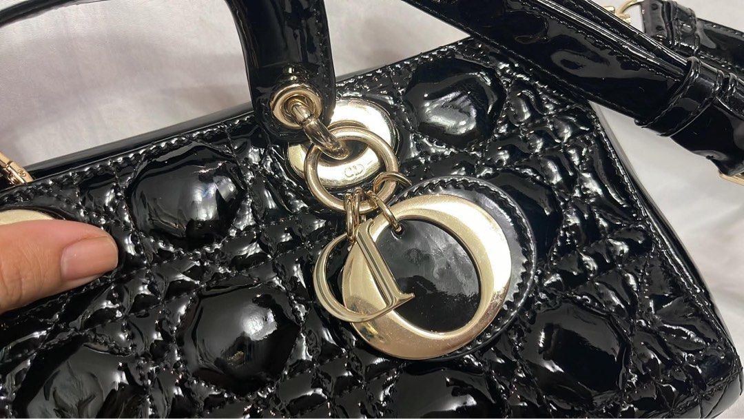 Black Patent Dior Lady Dior Bag (Category: Luxury Bags & Wallets) located in Lupao. Submitted by jennylynda42204 (Listing ID 1441905732, Image 2). Description: - Classic black patent leather Lady Dior bag - Iconic cannage stitching - Top handles - Detachable shoulder strap - Gold-tone hardware - Timeless and stylish for any occasion.