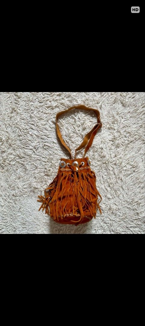 Brown Suede Fringe Bucket Bag (Category: Cross-body Bags) located in Caloocan City. Submitted by noy5o1a (Listing ID 1441816768, Image 1). Description: - Super cute brown suede bucket bag - Features lots of fringe detail all around - Drawstring closure with metal accents - Suede strap - Ideal for a boho or western vibe - Perfect size for essentials.