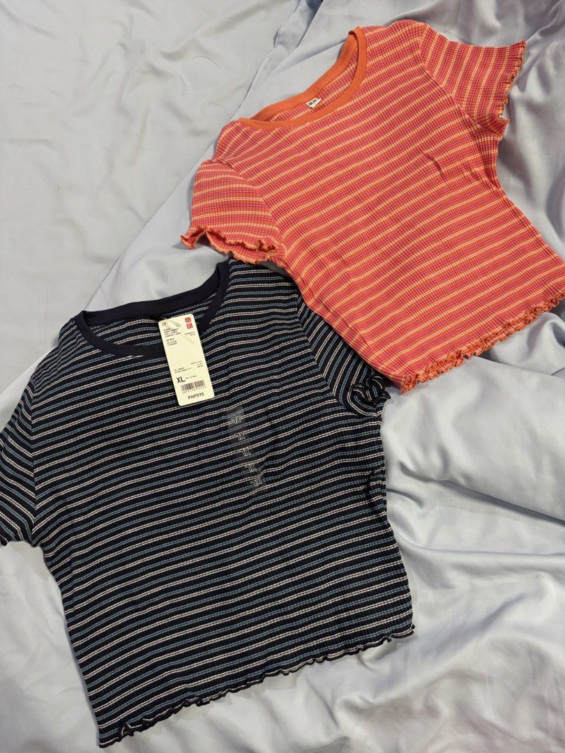 BUNDLE Uniqlo Striped Cropped T-Shirts (2 pcs) (Category: Shirts) located in Manila. Submitted by tinseyra (Listing ID 1441869622, Image 1). Description: - Two Uniqlo cropped t-shirts - Style 1: Coral/orange with yellow stripes SIZE L - Style 2: Navy with white and blue stripes SIZE XL - Both feature a cute lettuce hem detail - Navy shirt still has the original tag attached - Perfect for everyday casual outfits.
