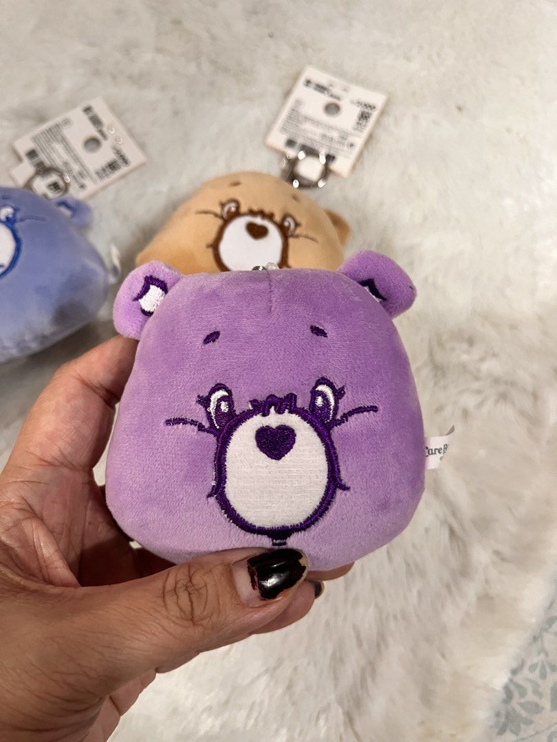 Care Bears Plush Keychain Coin Purse (Category: Plushies & Soft Toys) located in Quezon City. Submitted by cthy27 (Listing ID 1441798664, Image 3). Description: - adorable Care Bears plush coin purses. - Includes pink, purple, blue, and brown bears. - Each features a secure zipper closure. - Comes with a convenient metal keyring for easy attachment. - Ideal for storing coins, keys, earbuds, or other small essentials. - A must-have collectible for