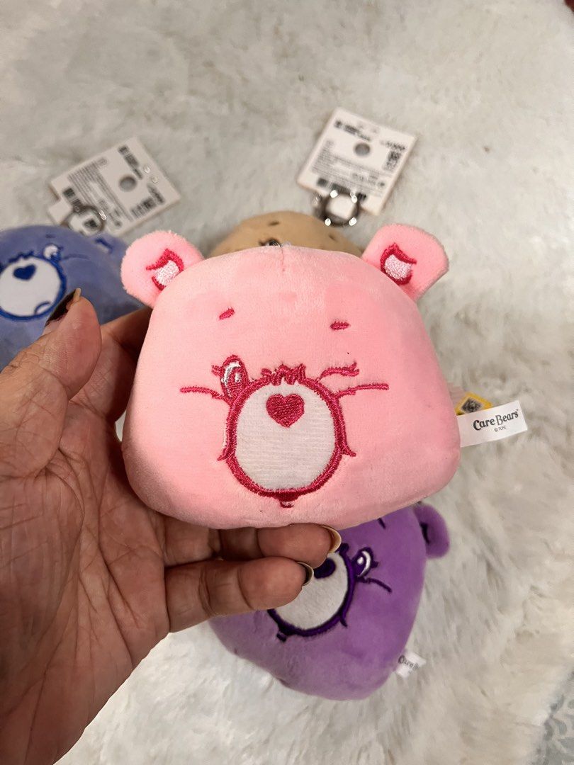Care Bears Plush Keychain Coin Purse (Category: Plushies & Soft Toys) located in Quezon City. Submitted by cthy27 (Listing ID 1441798664, Image 2). Description: - adorable Care Bears plush coin purses. - Includes pink, purple, blue, and brown bears. - Each features a secure zipper closure. - Comes with a convenient metal keyring for easy attachment. - Ideal for storing coins, keys, earbuds, or other small essentials. - A must-have collectible for