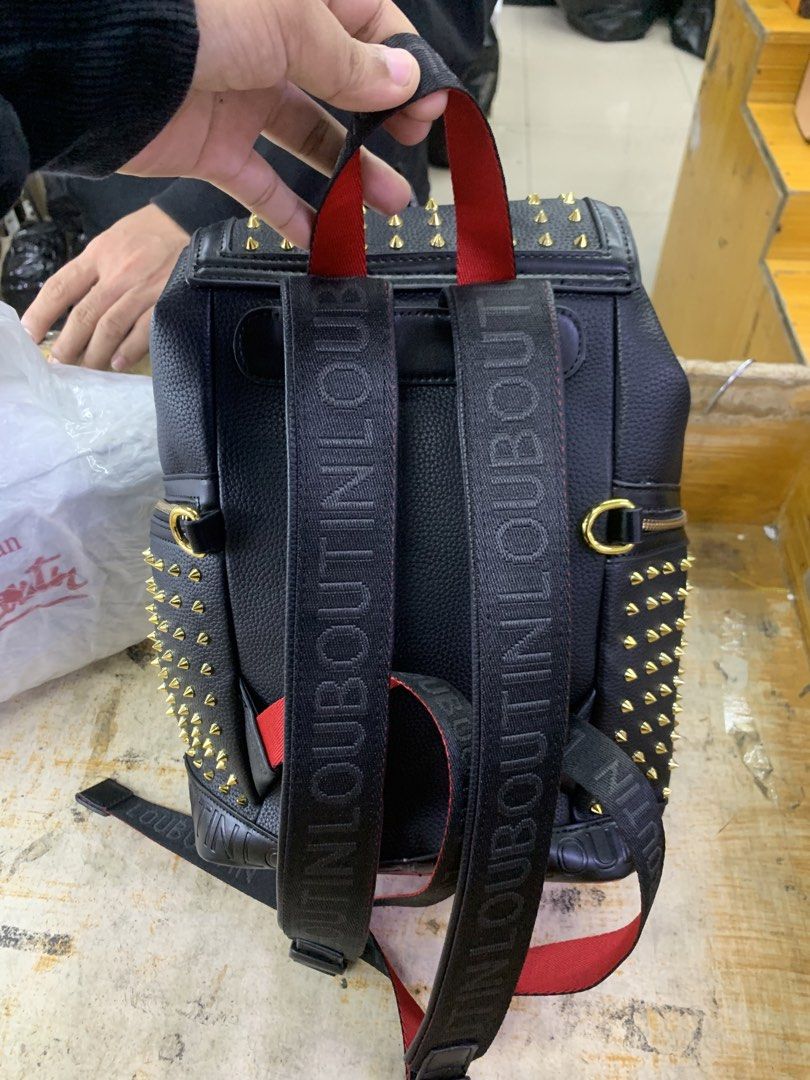 Christian Louboutin Black Spiked Leather Backpack (Category: Backpacks) located in Manila. Submitted by lichking416 (Listing ID 1441781588, Image 2). Description: - Black leather backpack with striking gold spikes - Luxurious red interior lining - Secure drawstring closure with a buckle flap - Convenient side zip pockets - Adjustable shoulder straps featuring Louboutin branding - Iconic red sole zipper pull detail - Ideal for everyday use or trav