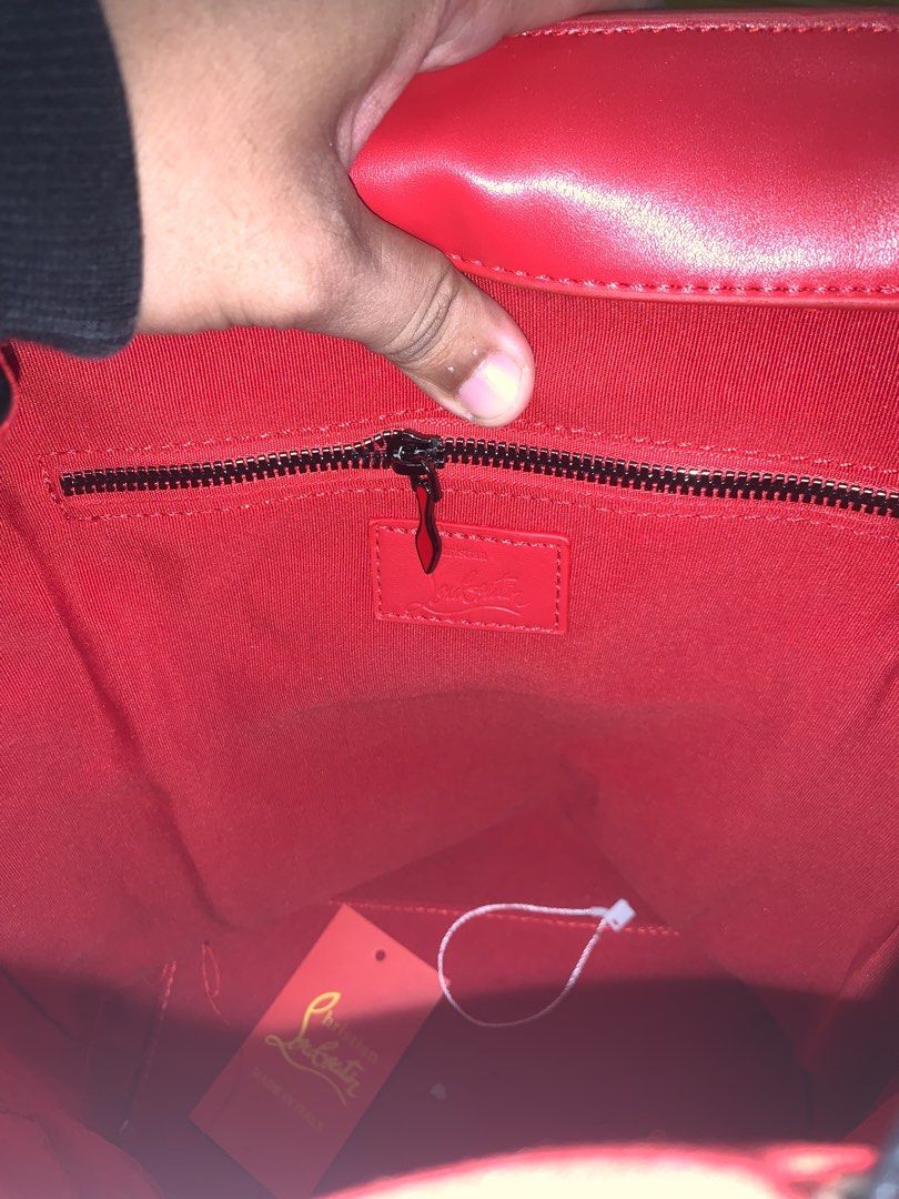 Christian Louboutin Black Spiked Leather Backpack (Category: Backpacks) located in Manila. Submitted by lichking416 (Listing ID 1441781588, Image 3). Description: - Black leather backpack with striking gold spikes - Luxurious red interior lining - Secure drawstring closure with a buckle flap - Convenient side zip pockets - Adjustable shoulder straps featuring Louboutin branding - Iconic red sole zipper pull detail - Ideal for everyday use or trav
