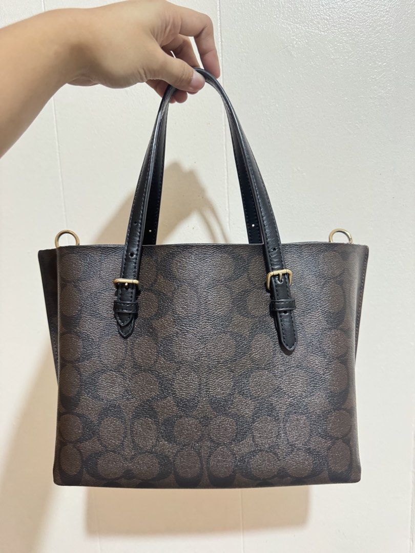 Coach Mollie tote bag (Category: Luxury Bags & Wallets) located in Manila. Submitted by eybeeee (Listing ID 1441920776, Image 2). Description: - Authentic Coach tote bag - Signature brown print with black leather handles and trim - Includes a convenient zippered pouch - Elegant gold hardware details - Spacious design, ideal for everyday essentials - Perfect for daily use and carrying all your necessities NEGOTIABLE. Pm lang po 🫶🏻.