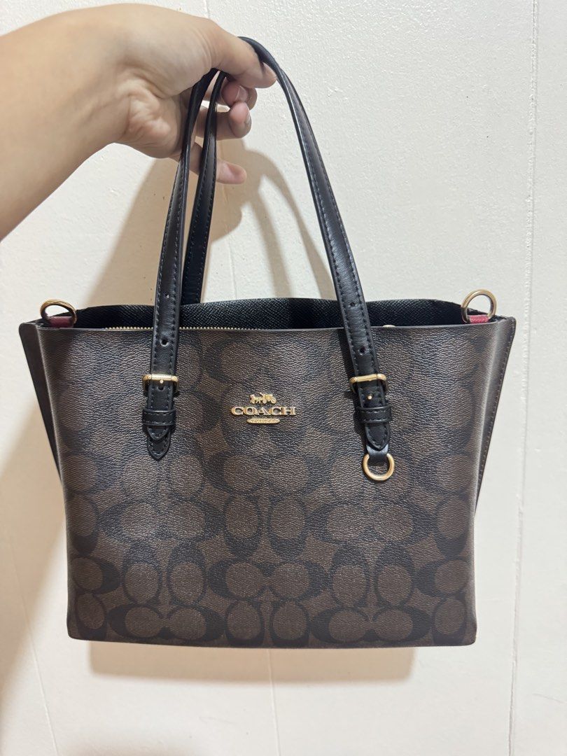 Coach Mollie tote bag (Category: Luxury Bags & Wallets) located in Manila. Submitted by eybeeee (Listing ID 1441920776, Image 1). Description: - Authentic Coach tote bag - Signature brown print with black leather handles and trim - Includes a convenient zippered pouch - Elegant gold hardware details - Spacious design, ideal for everyday essentials - Perfect for daily use and carrying all your necessities NEGOTIABLE. Pm lang po 🫶🏻.