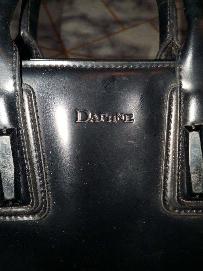 Daphne Black Patent Leather Tote hand Bag stand alone (Category: Tote Bags) located in Bulacan. Submitted by keroro1982 (Listing ID 1441785437, Image 3). Description: - Brand: Daphne - Material: Black patent leather - Design: Classic structured tote - Features: Top handles, side zippered pocket - Hardware: Gold-tone - Interior: Spacious - Perfect for: Work or everyday use.