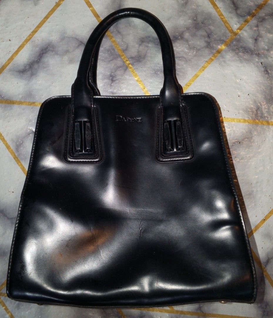 Daphne Black Patent Leather Tote hand Bag stand alone (Category: Tote Bags) located in Bulacan. Submitted by keroro1982 (Listing ID 1441785437, Image 2). Description: - Brand: Daphne - Material: Black patent leather - Design: Classic structured tote - Features: Top handles, side zippered pocket - Hardware: Gold-tone - Interior: Spacious - Perfect for: Work or everyday use.