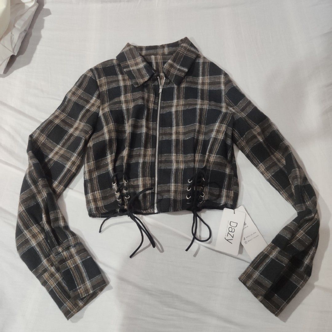 Dazy Plaid Lace-Up Cropped Shirt (Category: Blouses) located in Quezon City. Submitted by twinkle97 (Listing ID 1441891712, Image 1). Description: - Cute cropped plaid shirt from Dazy - Features a lace-up front with grommets and black ties - Long sleeves - Estimated size S - Versatile for layering or wearing alone - Ideal for a casual, edgy style.