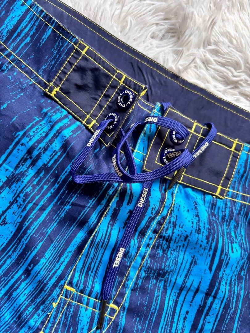 Diesel Board Shorts Blue Abstract Print (Category: Shorts) located in Catbalogan. Submitted by kristinapi (Listing ID 1441818976, Image 3). Description: - Brand: Diesel - Size: XL - Color/Print: Cool blue abstract print - Features: Drawstring waist, velcro fly, back pocket with button closure - Interior: Mesh lining - Ideal for: Swimming, pool lounging.