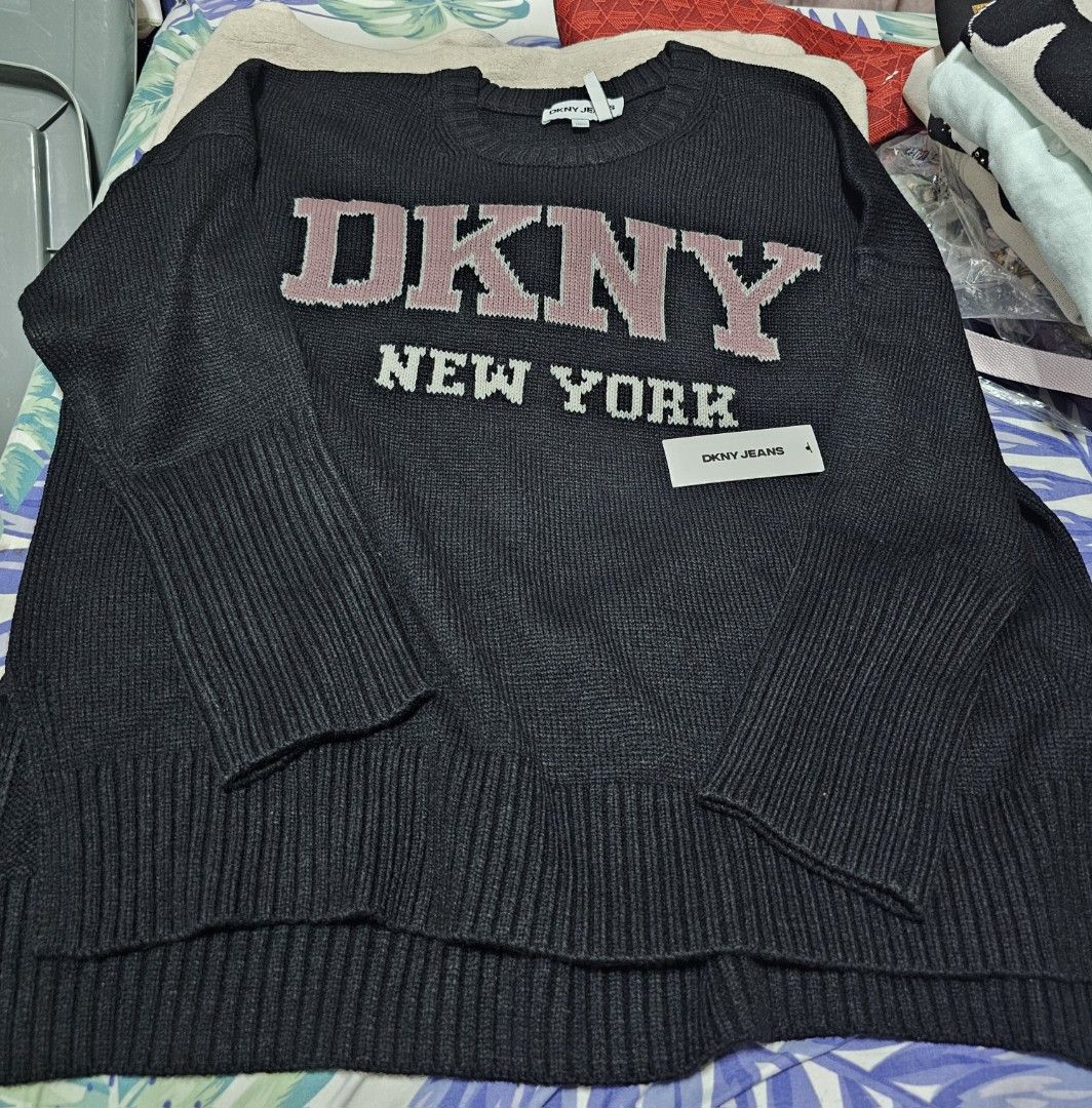 DKNY New York Knit Sweater (Category: Longsleeves) located in Davao. Submitted by dahl957172787 (Listing ID 1441946597, Image 1). Description: - Black DKNY New York knit sweater - Long sleeves with ribbed cuffs - Classic crew neck - Pink and white DKNY logo detail - Brand new with original tags attached - Ideal for casual wear.