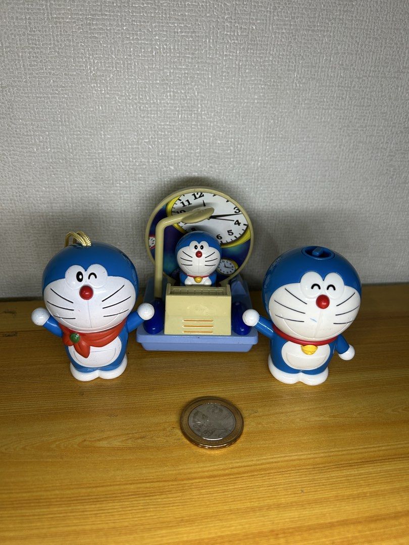 Doraemon Clock and Figures Set (Category: Clocks) located in Pateros City. Submitted by cleanmycloset (Listing ID 1441957572, Image 1). Description: - Adorable Doraemon themed clock - Includes 3 Doraemon figures - One figure is designed to be hanging - Ideal for Doraemon enthusiasts - Perfect for displaying on desks or shelves Preloved Toys. All items are declared AS IS. Pls manage your expectations. NO return; NO exchange. Can do tiiktokk checko