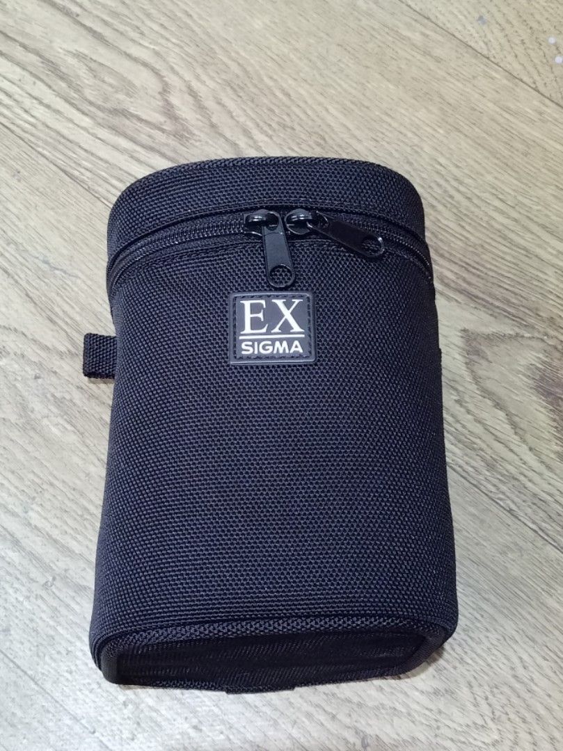 EX SIGMA Camera Lens Pouch Carrier (Category: Camera Bags & Carriers) located in San Fernando. Submitted by gelo.archive (Listing ID 1441807867, Image 1). Description: Black Sigma EX Camera Lens Case P 499 Zipper closure Includes a protective foam insert Features a belt loop for easy carrying - Designed for lens storage and transport.
