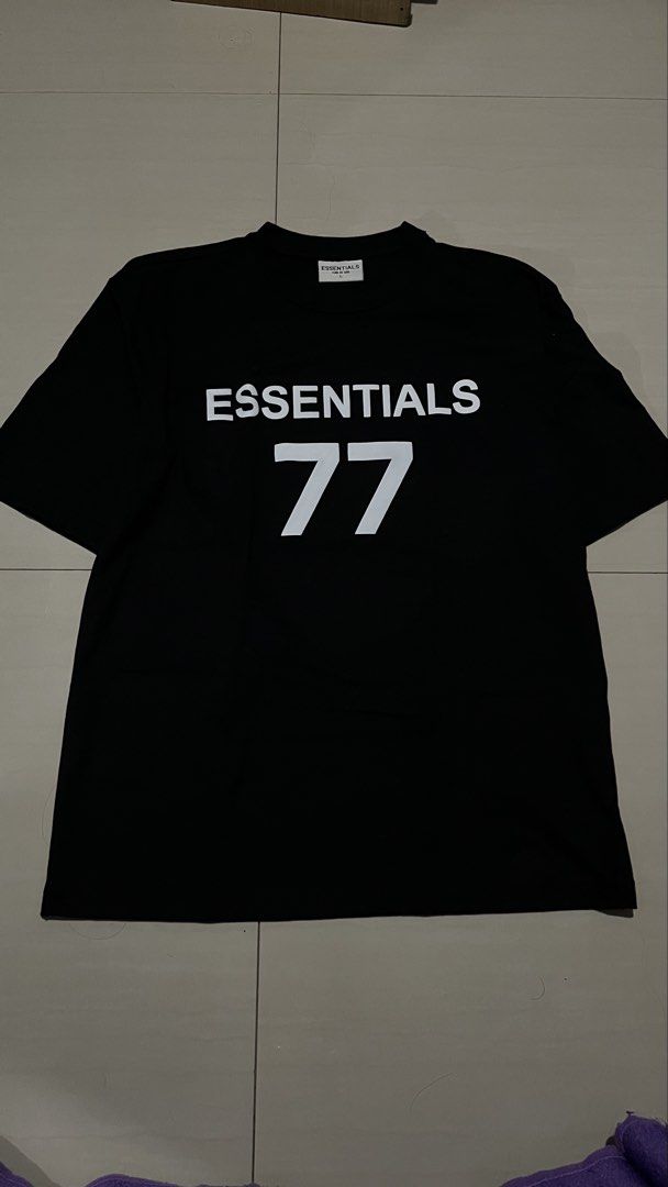 Fear of God Essentials 77 Black T-Shirt (Category: Tshirts & Polo Shirts ) located in Taguig. Submitted by mikejoshes65756 (Listing ID 1441927975, Image 1). Description: - Brand: Fear of God Essentials - Color: Black - Design: Features '77' graphic on the front - Style: Short sleeves, crew neck - Origin: Made in Bangladesh - Occasion: Ideal for casual wear.