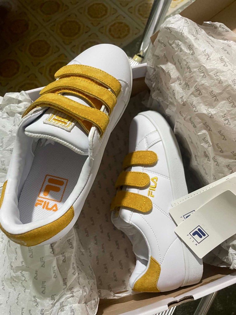 Fila White & Yellow Velcro Sneakers (Category: Sneakers) located in Baguio. Submitted by swishbaker (Listing ID 1441924068, Image 1). Description: - White Fila sneakers - Yellow accent details - Three velcro straps for easy adjustment - Includes original box and tags - Ideal for casual wear Feel free to message me for any inquiries.