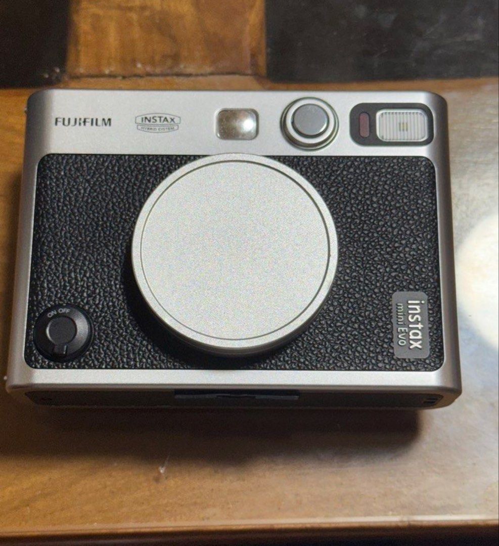 Fujifilm Instax Mini Evo Hybrid Instant Camera (Category: Cameras) located in Manila. Submitted by enhzlsells (Listing ID 1441900898, Image 3). Description: RFS- need funds and nit using it - Fujifilm Instax Mini Evo Hybrid Instant Camera - Combines digital and instant print capabilities - Features a rear screen for shot preview - Stylish silver and black design - Compatible with Instax Mini film.