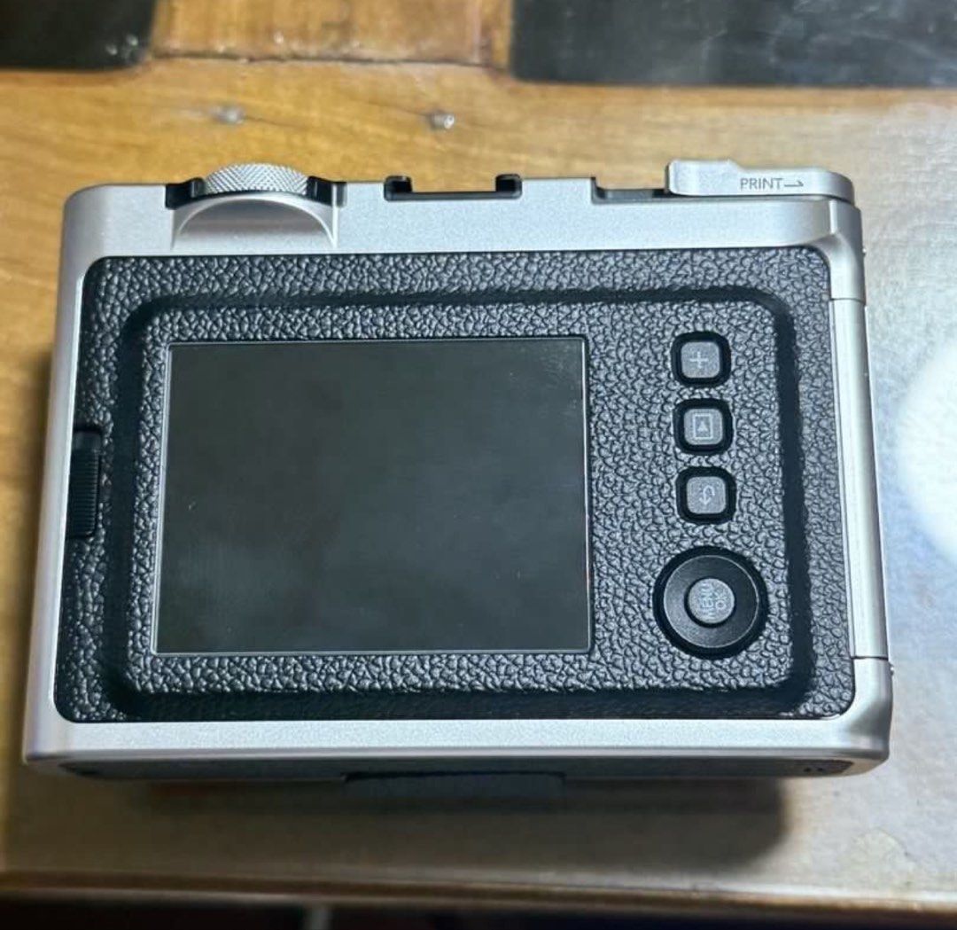 Fujifilm Instax Mini Evo Hybrid Instant Camera (Category: Cameras) located in Manila. Submitted by enhzlsells (Listing ID 1441900898, Image 2). Description: RFS- need funds and nit using it - Fujifilm Instax Mini Evo Hybrid Instant Camera - Combines digital and instant print capabilities - Features a rear screen for shot preview - Stylish silver and black design - Compatible with Instax Mini film.