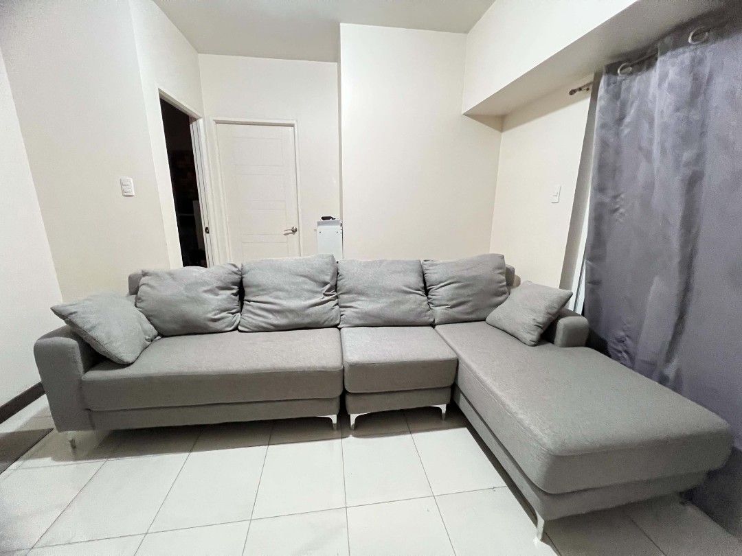 Grey L-Shaped Sectional Sofa with Chaise (Category: Sofas) located in Manila. Submitted by vernon27 (Listing ID 1441933561, Image 1). Description: OUR HOME Cyril II L-Shape Sofa / Sectional Sofa Bought for around ₱45,000. Selling for ₱28,000. Current/posted price from Our Home was around ₱45K depending on promo. Modern gray fabric L-shaped sofa with chaise lounge. Used with a sofa cover most of the time; cover was removed only for picture taking.