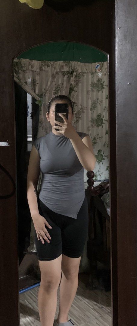 Grey Mock Neck Sleeveless Asymmetrical Top (Category: Sleeveless) located in Caloocan City. Submitted by kimpatchieee (Listing ID 1441917415, Image 1). Description: - Chic grey mock neck top - Sleeveless with short cap sleeves - Modern asymmetrical hemline - Comfortable stretchy fabric - Ideal for layering or standalone wear - Versatile for casual and dressed-up occasions.