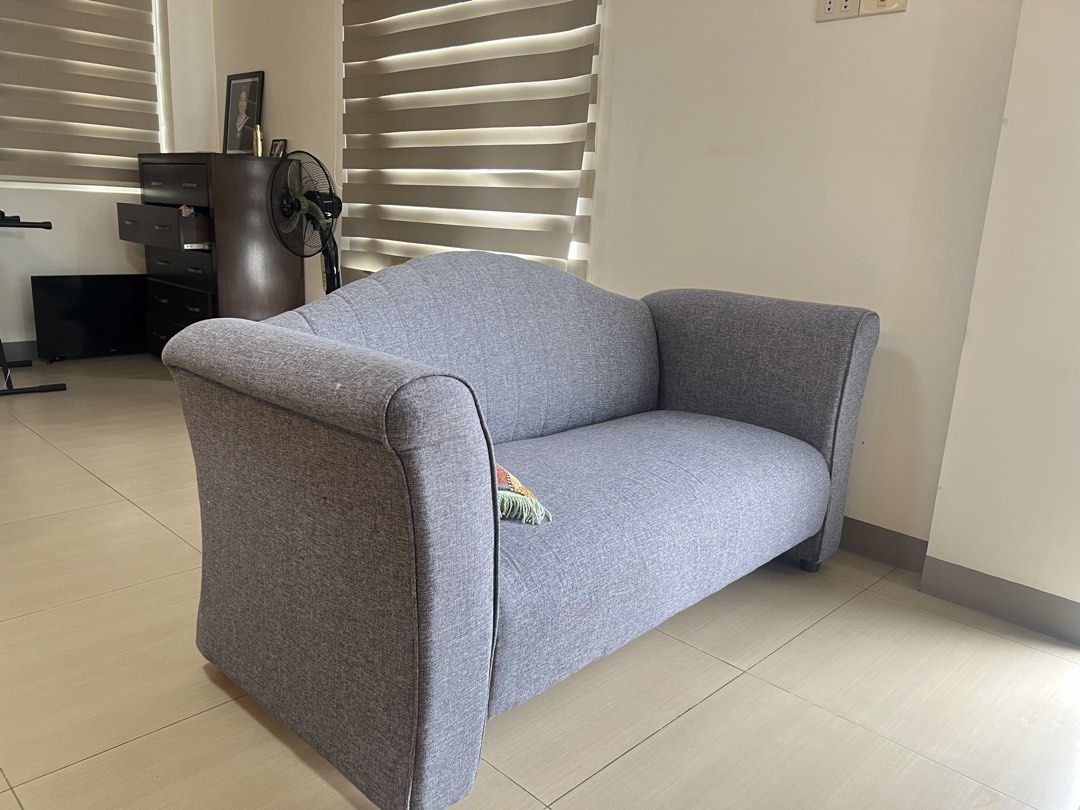 Grey Two-Seater Sofa with Curved Back (Category: Sofas) located in Quezon City. Submitted by jensineg (Listing ID 1441838892, Image 2). Description: - Grey Fabric Sofa - Two seater - 155cm x 50cm.