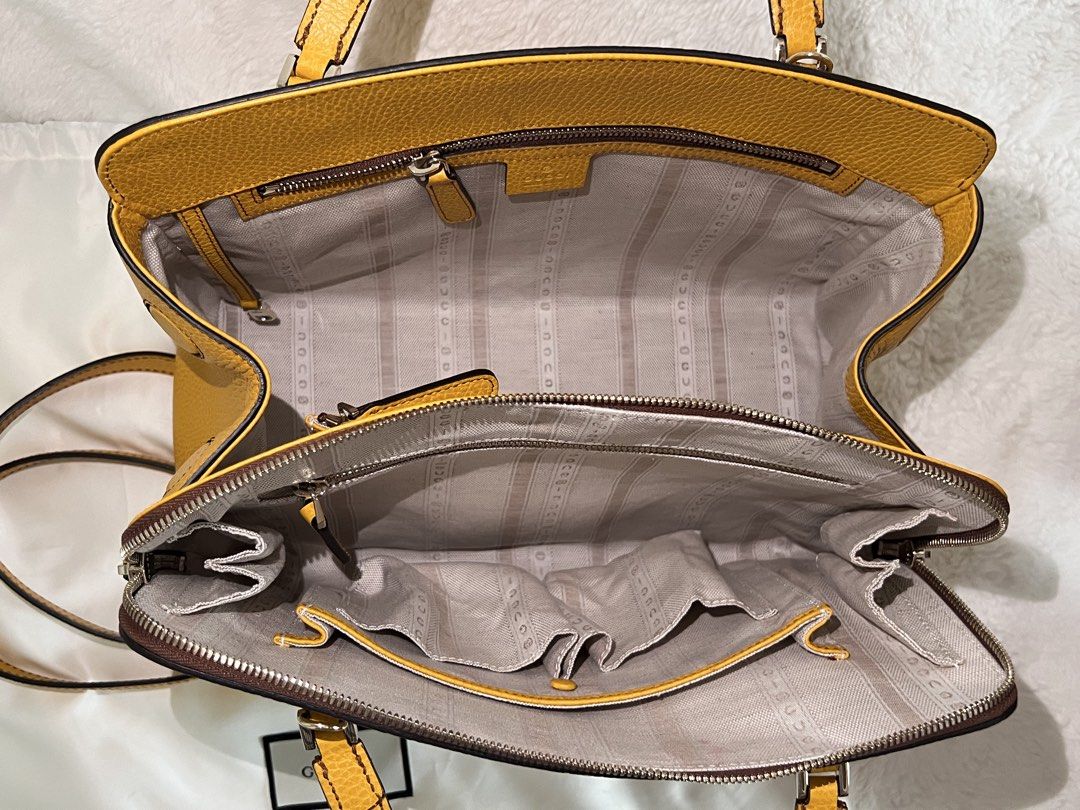 Gucci Yellow Leather Top Handle Bag with Strap (Category: Luxury Bags & Wallets) located in Cainta. Submitted by ginamit (Listing ID 1441790279, Image 2). Description: - Authentic Gucci two way bag - Genuine yellow pebbled leather - Detachable shoulder strap included - Multiple interior compartments and zip pockets - Protective metal feet on the bottom - Comes with original Gucci dust bag - Versatile for everyday or special events ***100% authent