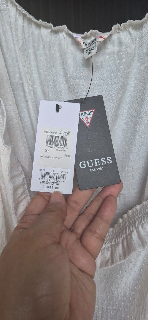 Guess Off Shouder Celestina Top with Tags (Category: Blouses) located in Quezon City. Submitted by yasisugar13 (Listing ID 1441910566, Image 2). Description: - Brand: Guess - Item: Off shoulder Celestina top -color: Off white - Size: XL on tag - Fabric: Textured french/swiss dots - Condition: Brand new with original tags attached - Style: Perfect for casual or dressy outfits - Best fit to 40-42.