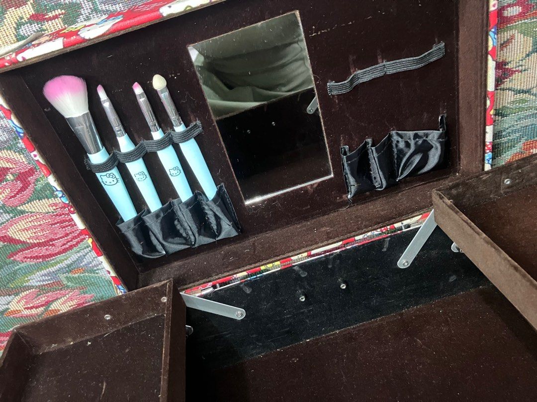 Hello Kitty Makeup Tool Case with Mirror (Category: Makeup) located in Solano. Submitted by ayracorinne (Listing ID 1441885642, Image 3). Description: - Adorable red Kitty makeup train case with a fun all-over print. - Includes a built-in mirror for on-the-go touch-ups. - Features elastic straps to securely hold your makeup brushes. - Comes with convenient pull-out trays for organized storage. - Ideal for keeping your makeup collection tidy or pa