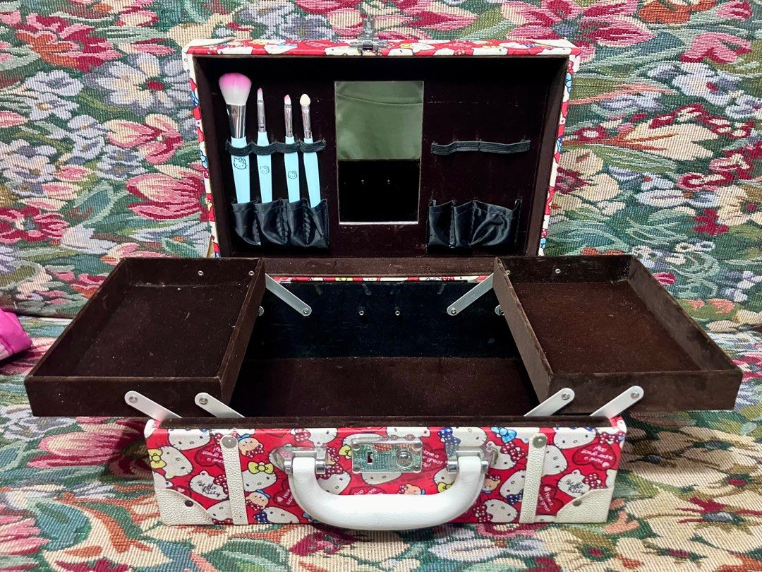 Hello Kitty Makeup Tool Case with Mirror (Category: Makeup) located in Solano. Submitted by ayracorinne (Listing ID 1441885642, Image 1). Description: - Adorable red Kitty makeup train case with a fun all-over print. - Includes a built-in mirror for on-the-go touch-ups. - Features elastic straps to securely hold your makeup brushes. - Comes with convenient pull-out trays for organized storage. - Ideal for keeping your makeup collection tidy or pa