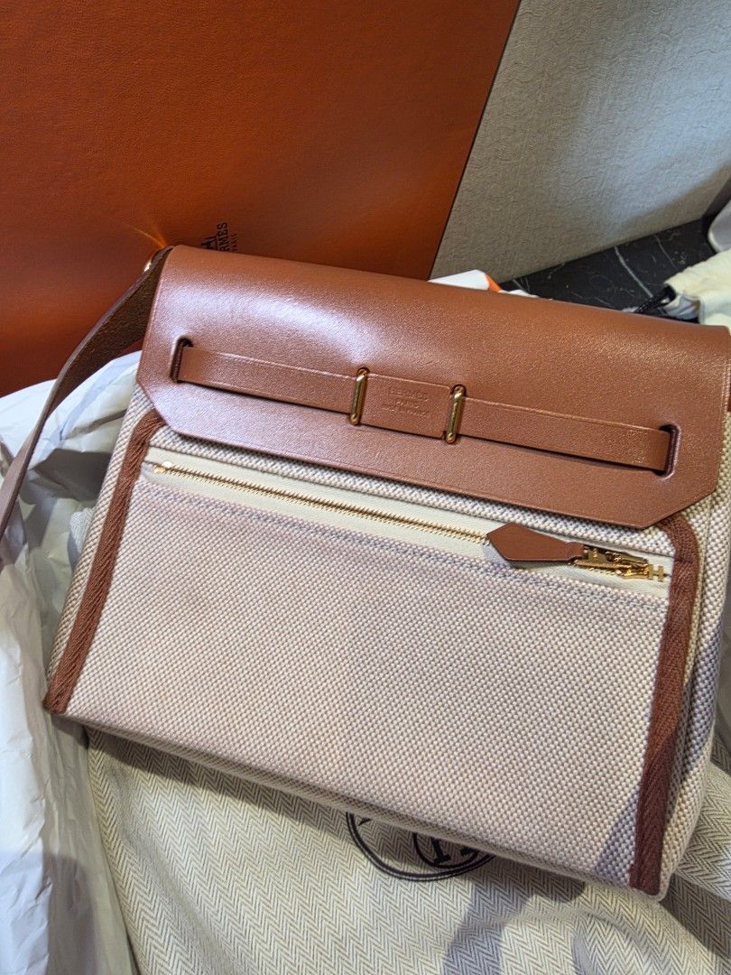 Hermes Herbag Mini 20 Authentic (Category: Cross-body Bags) located in Pasig City. Submitted by vthing (Listing ID 1441820121, Image 2). Description: Includes: • Original Hermès box • Dust bag • Shoulder strap and proof of purchase Condition: Excellent pre-loved condition with minimal signs of wear as seen on photo. A timeless and sophisticated Hermès piece that combines luxury, practicality, and effortless style. Hermès Herbag 20 Retourne – Fauv